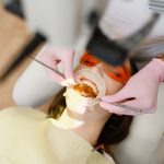 female-dentist-patient-with-opened-mouth-clinic-top-view-stomatology-min